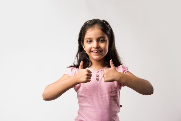 cute-little-indian-asian-girl-showing-thumbs-up-sign-standing-isolated-white-background_466689-55227